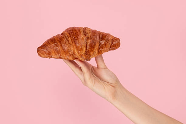 istock Woman presenting sweet croissant bun 1162388106