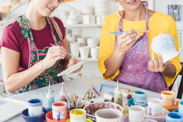 istock Two women painting own ceramic tableware in DIY workshop 1162388357