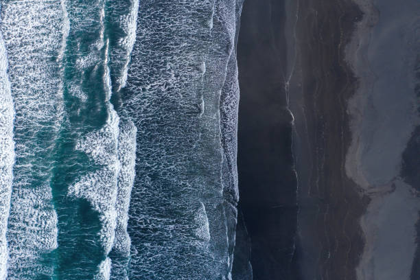 istock Aerial view of Atlantic ocean waves washing black sandy beach 1162388593