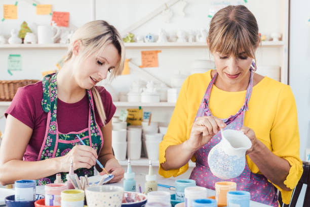 istock Two women painting own ceramic tableware in DIY workshop 1162389256