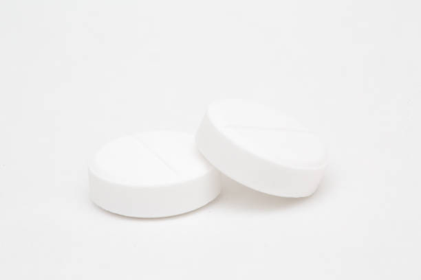 istock White pills closeup isolated on white background 1162389299