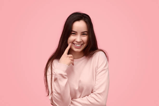 istock Cheerful teenager poking cheek 1162390842