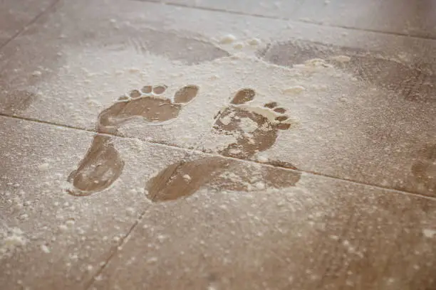 Photo of Foot print on flour on the floor.