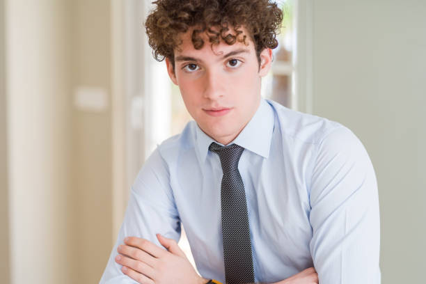 istock Young business man wearing a tie Relaxed with serious expression on face. Simple and natural with crossed arms 1162392980