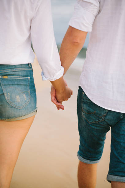 istock A man and woman hold hands and walk 1162393779