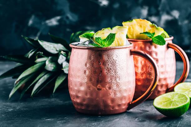 istock Iced Cold Moscow Mule cocktail with lime and pineapple on dark background 1162395186