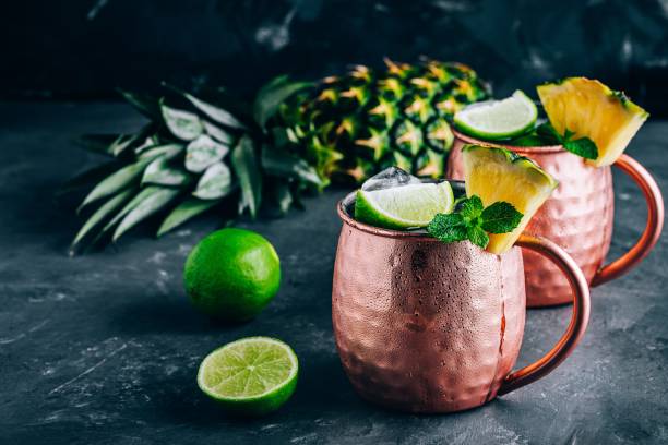 istock Iced Cold Moscow Mule cocktail with lime and pineapple on dark background 1162395231