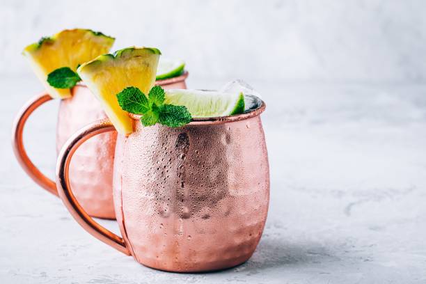 istock Iced Cold Moscow Mule cocktail with lime and pineapple on dark background 1162395241