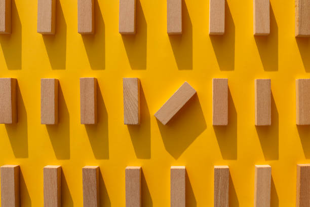 istock Wooden blocks on yellow background 1162395292