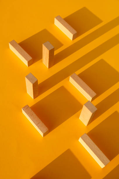istock Wooden blocks on yellow background 1162395587