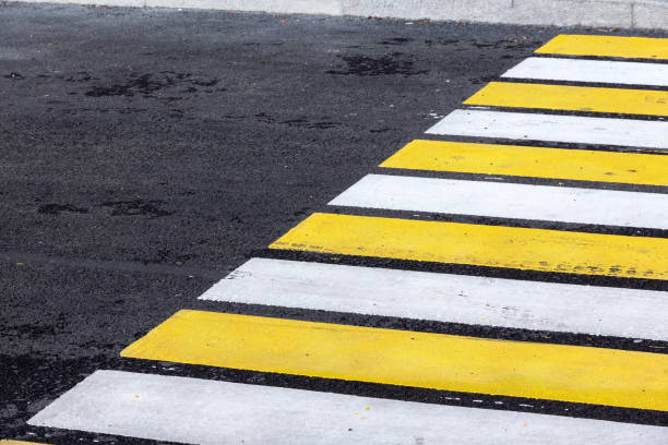 istock crosswalk zebra with yellow and white stripes 1162397035
