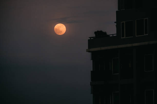 istock full moon and city night with grain 1162398948