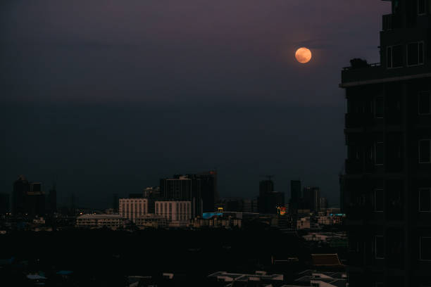 istock full moon and city night with grain 1162399080