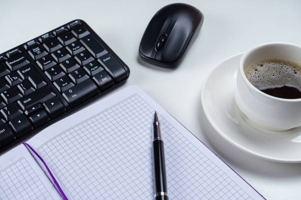 office table desk. workspace with blank note book, keyboard, office supplies and coffee cup on white background. - spiral notebook audio imagens e fotografias de stock