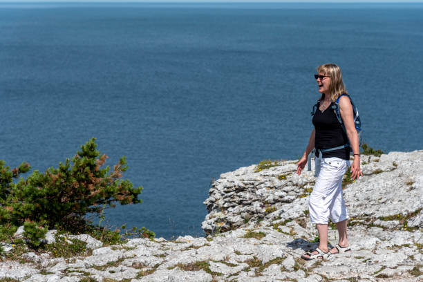 istock Woman hiking on sea shore 1162400300