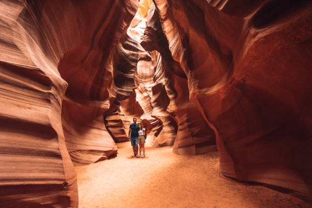 Couple portrait inside Antelope Canyon Couple portrait inside Antelope Canyon upper antelope canyon stock pictures, royalty-free photos & images