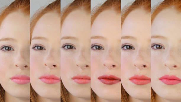 image of pretty teenager girl / young woman wearing makeup and different shades of lipstick side by side, pink and red lipsticks on teenage girl 14 / 15 / 16 years old, selfie pouting lips and red ginger hair, pale white skin with freckles and brown eyes - 16 17 years vibrant color beauty red imagens e fotografias de stock
