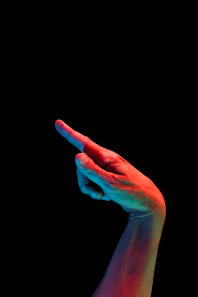 istock Bright fluorescent colorful hands isolated on a dark background. Close-up. 1162404095