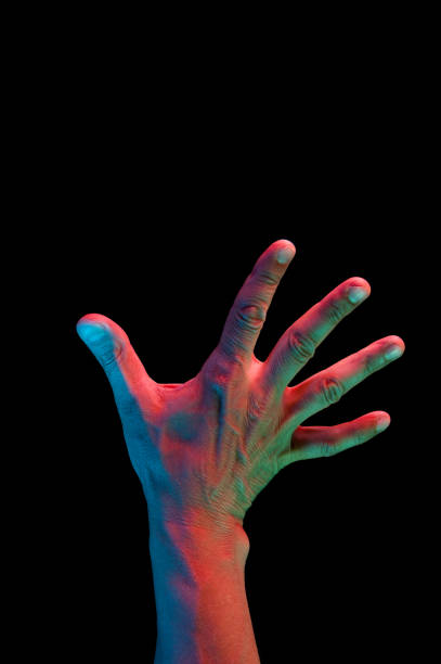 istock Bright fluorescent colorful hands isolated on a dark background. Close-up. 1162404116