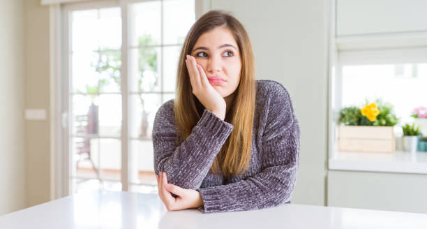 istock Beautiful young woman at home thinking looking tired and bored with depression problems with crossed arms. 1162406788