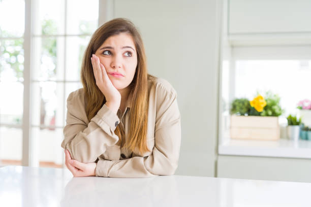 istock Beautiful young woman at home thinking looking tired and bored with depression problems with crossed arms. 1162406883