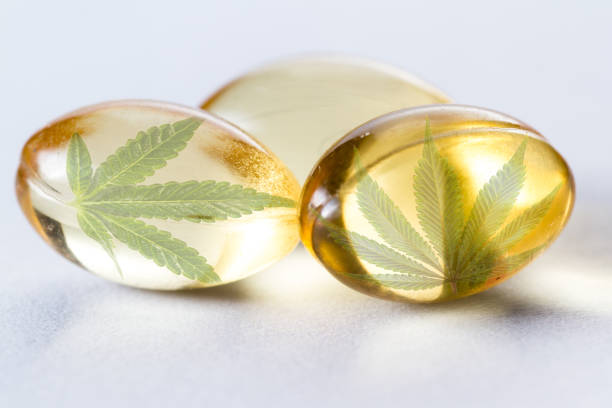 CBD oil concept close up of a cannabis oil capsule composit image as a product concept palm fiber stock pictures, royalty-free photos & images