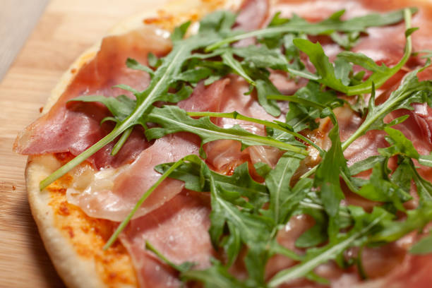 istock Close up of Pizza with prosciutto (parma ham) and  arugula (salad rocket) 1162408320