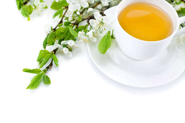 istock Green tea in a ceramic cup with branches of blossoming apple tree 1162408570