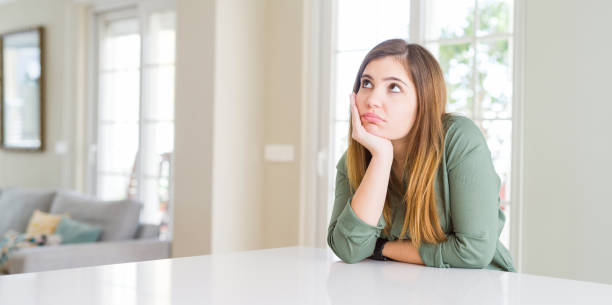 istock Beautiful young woman at home thinking looking tired and bored with depression problems with crossed arms. 1162408814