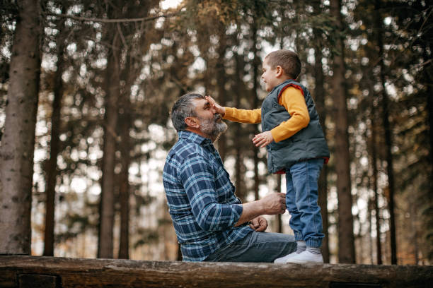 istock Grandfather playing with his grandson in public park 1162408835