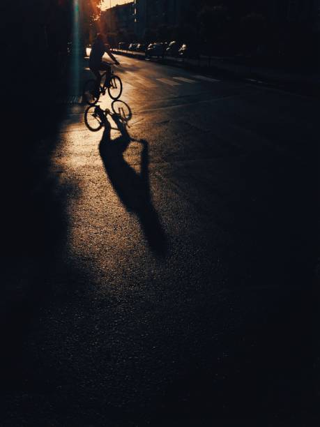 istock Focus on cyclist shadow on the road 1162408874