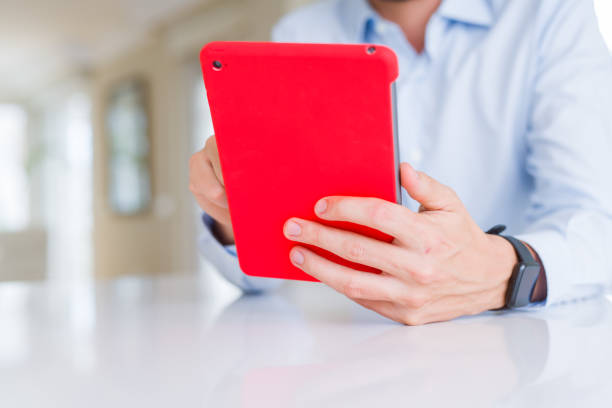 istock Close up of man hands using tablet and smiling 1162409872