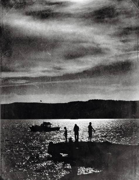 istock Monochrome view of three people on the seaside 1162410357