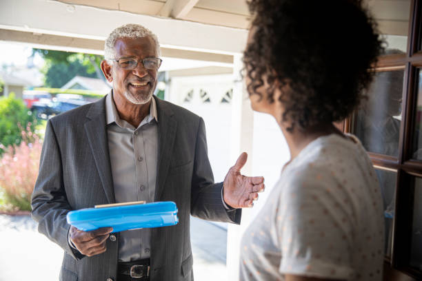 Senior Black Politician Door to Door A senior black man visits with a potential voter to earn her support. president photos stock pictures, royalty-free photos & images