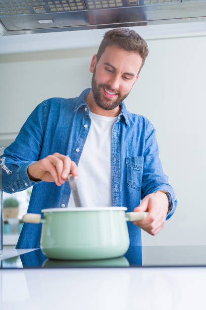 istock Handsome man cooking pasta at home 1162411329