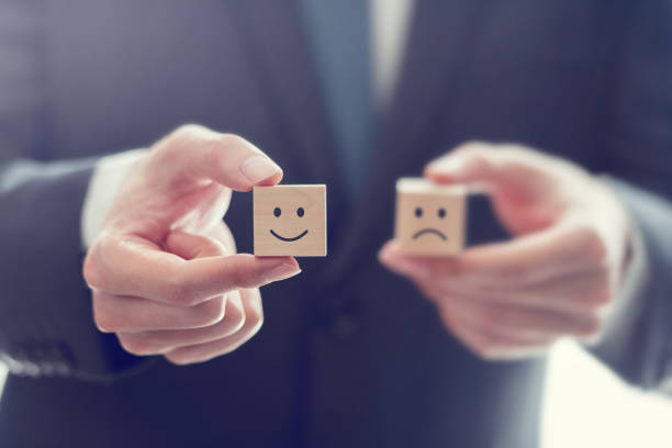 businessman choose smiley face and blurred sad face icon on wood cube, service rating, satisfaction concept. - rating ranking quality control aspirations imagens e fotografias de stock