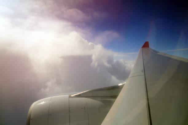 Close-up of airplane wing flying at sunrise