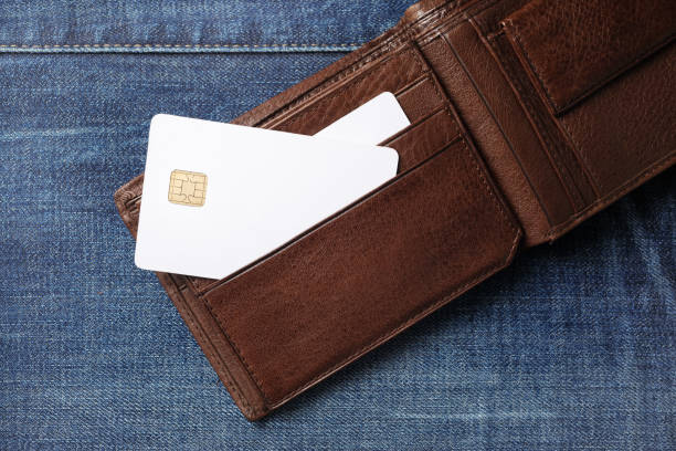 Credit cards in wallet Blank white credit cards in leather wallet on denim background. Flat lay. briefcase photos stock pictures, royalty-free photos & images