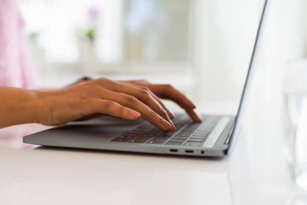 istock Close up of young woman working typing using laptop 1162419058