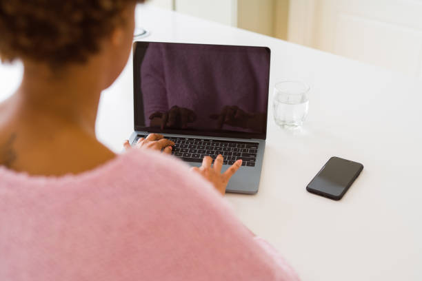 istock Close up of young woman working typing using laptop 1162419067