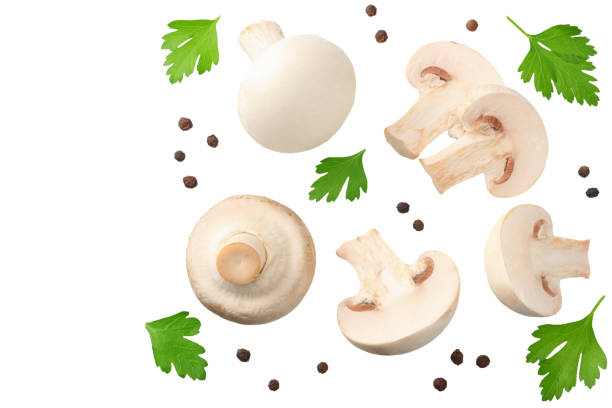 istock mushrooms with slices, parsley leaf and peppercorns isolated on white background. top view 1162419212