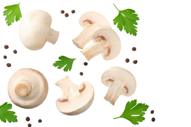 istock mushrooms with slices, parsley leaf and peppercorns isolated on white background. top view 1162419236