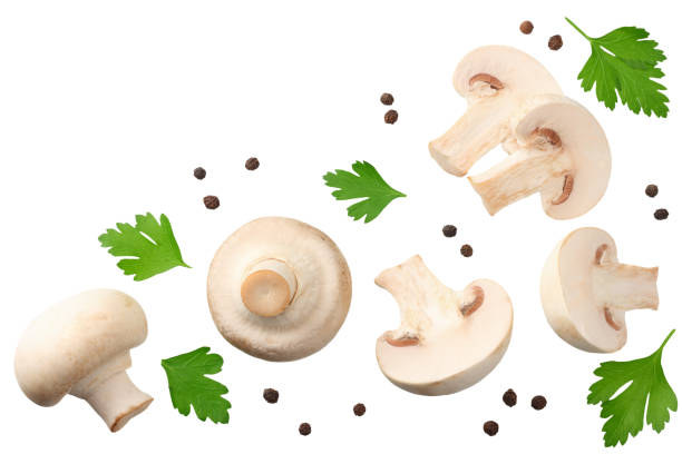 istock mushrooms with slices, parsley leaf and peppercorns isolated on white background. top view 1162419241