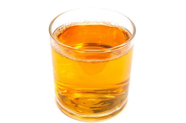istock Apple juice in a glass isolated on white 1162419636