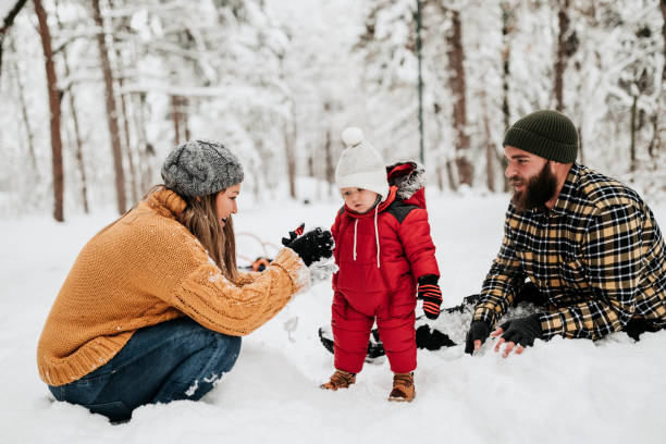 istock Let's cover up dad with snow 1162421569