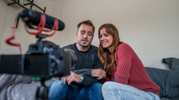 istock Man and woman recording video for vlogging 1162421608