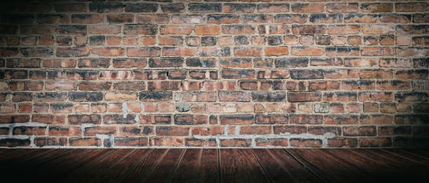 istock Vintage brick wall and wood floor, empty room. Panoramic background texture, copy space 1162421628