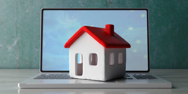 House model on a computer laptop, wooden office desk. 3d illustration