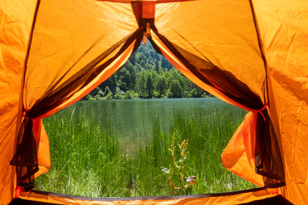 istock Camping tent at scenic campsite on a lake 1162422671