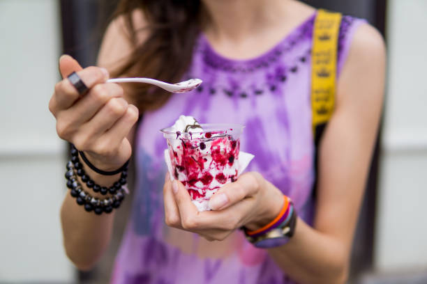 girl holding ice cream, woman eating ice-cream